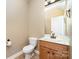 Bathroom with a toilet, vanity, mirror, and tile flooring at 8137 Caliterra Dr, Charlotte, NC 28227