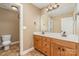 Double sink vanity with wood cabinets and a tiled floor in this bathroom at 8137 Caliterra Dr, Charlotte, NC 28227