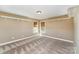 A spacious bedroom with carpeted floors, two windows, and a neutral color scheme at 8137 Caliterra Dr, Charlotte, NC 28227