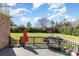 A spacious deck with a grill and outdoor furniture overlooking a large grassy yard at 8137 Caliterra Dr, Charlotte, NC 28227