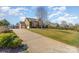 Long driveway leading to a three-car garage and a well-maintained lawn at 8137 Caliterra Dr, Charlotte, NC 28227