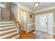 Welcoming foyer with hardwood floors, staircase, and decorative front door at 8137 Caliterra Dr, Charlotte, NC 28227