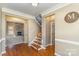 Inviting foyer with hardwood floors, staircase, and stone fireplace view at 8137 Caliterra Dr, Charlotte, NC 28227