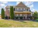 Beautiful brick two-story home with covered front porch and well-manicured lawn at 8137 Caliterra Dr, Charlotte, NC 28227