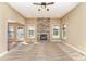 Cozy living room with stone fireplace, carpet flooring, and access to outdoor space at 8137 Caliterra Dr, Charlotte, NC 28227