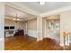 Open-concept living room with hardwood floors and views into the adjoining rooms at 8137 Caliterra Dr, Charlotte, NC 28227