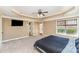 Large main bedroom boasting a tray ceiling, exterior access, neutral carpet, and ensuite bathroom at 8137 Caliterra Dr, Charlotte, NC 28227