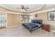 Spacious main bedroom with a tray ceiling, neutral carpet, ceiling fan, and access to the exterior at 8137 Caliterra Dr, Charlotte, NC 28227