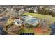 Aerial view of community pool, clubhouse, tennis court, and playground amenities at 8606 Chatsworth Ln, Waxhaw, NC 28173