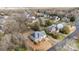 Expansive aerial view of neighborhood with lush trees surrounding a two-story home with gray roof at 8606 Chatsworth Ln, Waxhaw, NC 28173