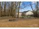 View of the backyard featuring a fire pit with a well maintained lawn and wooded area at 8606 Chatsworth Ln, Waxhaw, NC 28173
