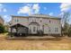 Back exterior view of house and a covered patio with plenty of seating in the backyard at 8606 Chatsworth Ln, Waxhaw, NC 28173