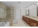 Tiled bathroom with glass shower, soaking tub, dual vanity and granite countertops at 8606 Chatsworth Ln, Waxhaw, NC 28173