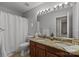 Bathroom featuring a double sink vanity with granite counters and a shower with curtain at 8606 Chatsworth Ln, Waxhaw, NC 28173