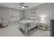 Comfortable bedroom featuring a desk, nightstand, ceiling fan, and beachy décor at 8606 Chatsworth Ln, Waxhaw, NC 28173