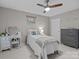 Well-lit bedroom with a dresser, decorative mirror, ceiling fan, and natural light at 8606 Chatsworth Ln, Waxhaw, NC 28173