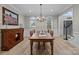 Bright dining room with a wooden table, chandelier, and adjacent staircase at 8606 Chatsworth Ln, Waxhaw, NC 28173