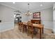 Elegant dining room with a wooden table, chandelier, and adjacent kitchen at 8606 Chatsworth Ln, Waxhaw, NC 28173