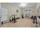 Bright exercise room featuring updated floors, plenty of natural light, and an array of gym equipment at 8606 Chatsworth Ln, Waxhaw, NC 28173
