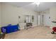 Spacious exercise room with updated floors, large mirror, neutral paint, and several workout machines at 8606 Chatsworth Ln, Waxhaw, NC 28173