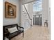 Grand foyer featuring a high ceiling, chandelier, staircase, and a decorative bench at 8606 Chatsworth Ln, Waxhaw, NC 28173