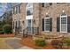 Charming entryway showcasing a gray front door, black railings and manicured landscaping at 8606 Chatsworth Ln, Waxhaw, NC 28173