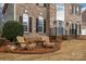 Inviting front yard featuring a brick facade, and outdoor seating area at 8606 Chatsworth Ln, Waxhaw, NC 28173