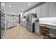 Bright kitchen featuring stainless steel appliances, lots of cabinet space, modern counters, and hardwood floors at 8606 Chatsworth Ln, Waxhaw, NC 28173