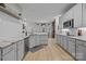 Bright kitchen features white cabinets, granite counters, stainless appliances, and hardwood floors at 8606 Chatsworth Ln, Waxhaw, NC 28173