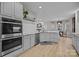 Spacious kitchen with white cabinets, stainless steel appliances, and hardwood flooring at 8606 Chatsworth Ln, Waxhaw, NC 28173