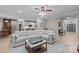 Open-concept living room with hardwood floors, large sofa, and seamless flow to the dining area and staircase at 8606 Chatsworth Ln, Waxhaw, NC 28173
