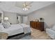 Spacious main bedroom featuring tray ceiling, ceiling fan and a wooden dresser at 8606 Chatsworth Ln, Waxhaw, NC 28173