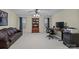 Office area featuring leather sofa, bookcase, large monitor, and natural light from windows at 8606 Chatsworth Ln, Waxhaw, NC 28173