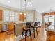 Kitchen with granite countertops, breakfast bar, wooden cabinets, and hardwood floors at 8915 Heydon Hall Cir, Charlotte, NC 28210