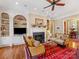 Comfortable living room with fireplace, built-in bookshelves, hardwood floors and neutral decor at 8915 Heydon Hall Cir, Charlotte, NC 28210