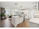 Open-concept kitchen with white cabinets, stainless steel appliances, and views into the living area at 960 Exeter Dr, Sherrills Ford, NC 28673