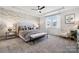 Serene main bedroom features a tray ceiling, decorative wallpaper, and abundant natural light from the windows at 960 Exeter Dr, Sherrills Ford, NC 28673
