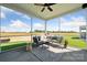 Relaxing screened porch with outdoor seating, ceiling fan, and views of the surrounding greenery at 960 Exeter Dr, Sherrills Ford, NC 28673
