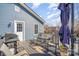Exterior view of a deck area with a grill, a table, chairs, and a shade umbrella for outdoor enjoyment at 1016 E 10Th St, Kannapolis, NC 28083