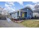 Charming blue home with a welcoming yellow door, accessible ramp, and landscaped front yard at 1016 E 10Th St, Kannapolis, NC 28083