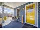 Charming covered front porch with a seating area, a yellow front door, and a warm, welcoming feel at 1016 E 10Th St, Kannapolis, NC 28083
