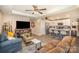 Inviting living room features a ceiling fan, a fireplace, comfortable seating, and access to the kitchen area at 1016 E 10Th St, Kannapolis, NC 28083