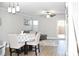 Open-concept living and dining area with a ceiling fan, wood floors and access to the backyard at 12742 Spirit Bound Way, Charlotte, NC 28273