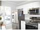 White kitchen featuring stainless appliances and granite countertops at 12742 Spirit Bound Way, Charlotte, NC 28273
