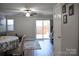 Light-filled living room features hardwood floors, sliding glass door and modern ceiling fan at 12742 Spirit Bound Way, Charlotte, NC 28273