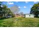 Expansive backyard featuring a shed and a white building alongside a charming brick home at 1301 Old Farm Rd, Charlotte, NC 28226