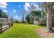 Lush backyard with a storage shed, fence, and mature trees offering a serene outdoor space at 1301 Old Farm Rd, Charlotte, NC 28226