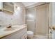 Bathroom with a shower, floral wallpaper, and a white vanity at 1301 Old Farm Rd, Charlotte, NC 28226