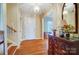 Inviting foyer with hardwood floors, a decorative mirror, and a staircase leading to the upper level at 1301 Old Farm Rd, Charlotte, NC 28226