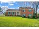Charming brick home featuring a well-manicured lawn, traditional shutters, and a welcoming front entrance at 1301 Old Farm Rd, Charlotte, NC 28226